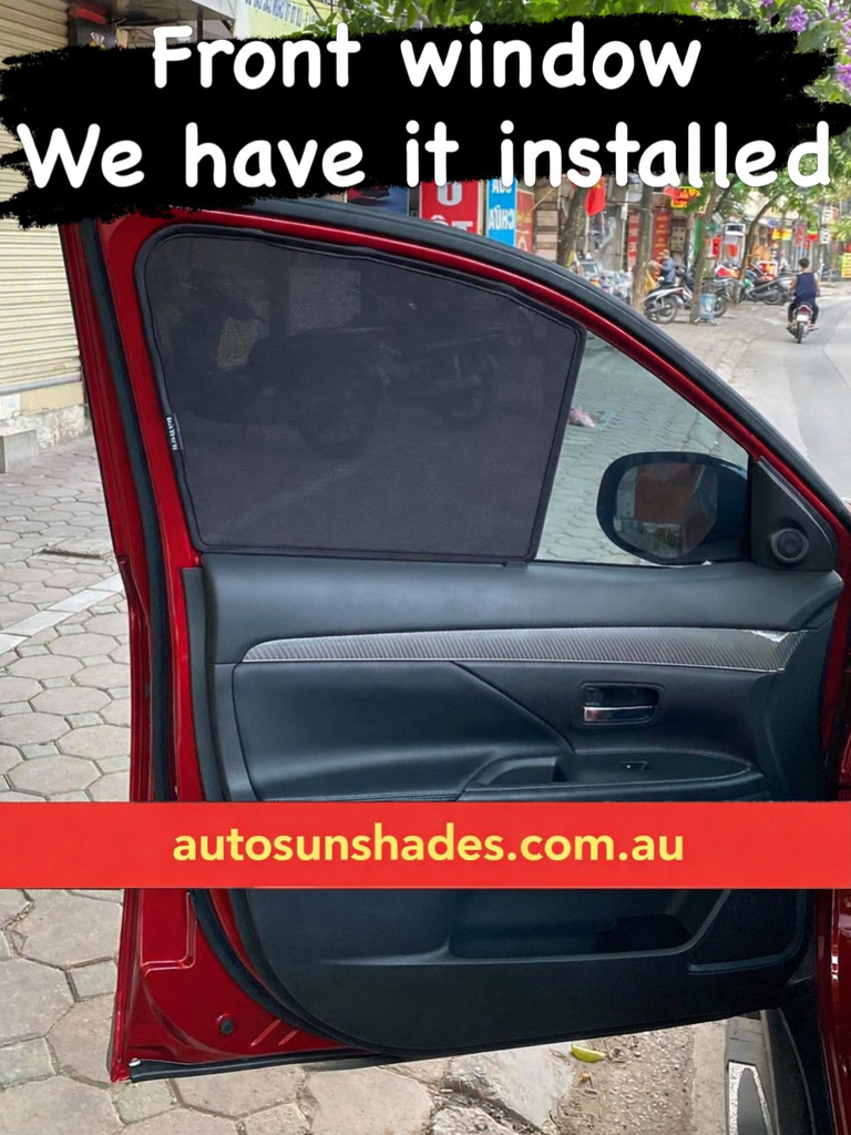 Hands snapping a magnetic sun shade into place on a rear passenger window